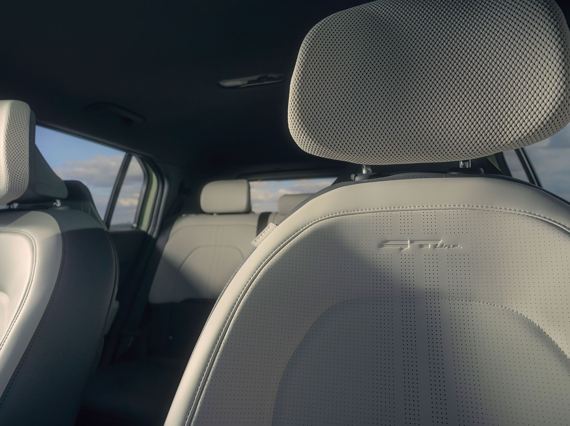 Close-up view of a car seat headrest and rear seats.