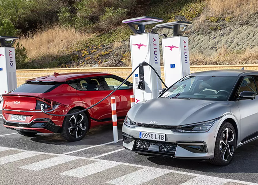 Long range Kia electric car, charging via an ultra-fast public EV charger during a long-distance journey