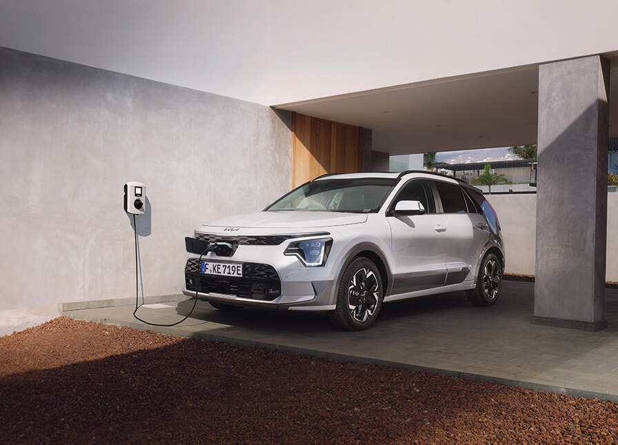 A Kia Electric car charging at home via an Electric car charger installed at home