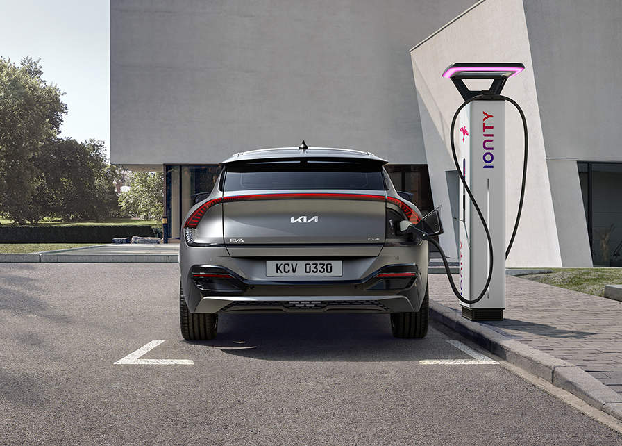 A Kia Electric car charging on the road with an Ionity Power ultra-fast electric car charger