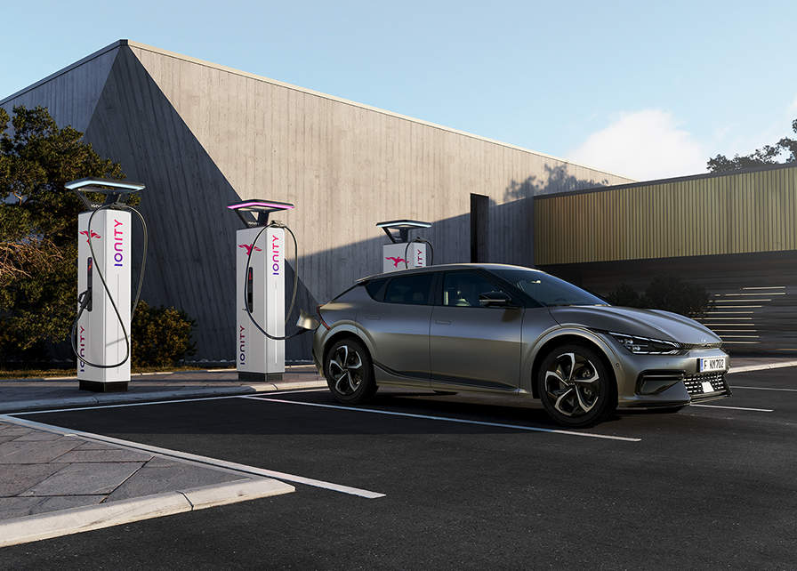 Kia electric car using ultra-fast charging at a public EV charging station, using Kia's bolt-on Ionity subscription.