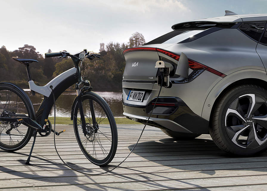 A Kia Electric car using Vehicle-to-Load to charge an electric bike