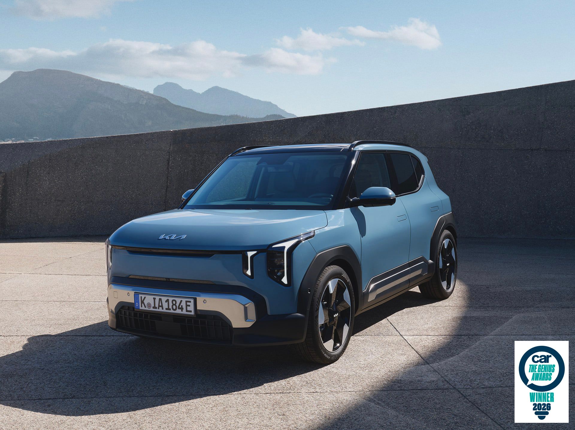 Front-side view of Kia EV2 with mountains in the background