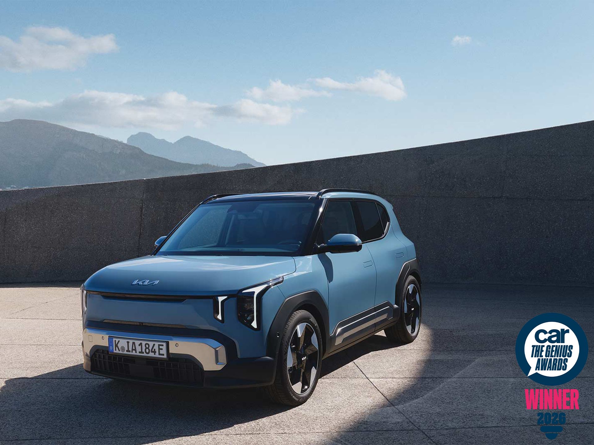 Front-side view of Kia EV2 with mountains in the background