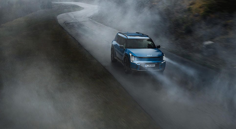 Kia EV9 driving in foggy weather.