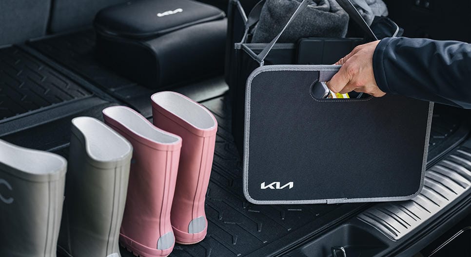 Inside of a Kia, which includes a Kia boot organsier and wellington boots.