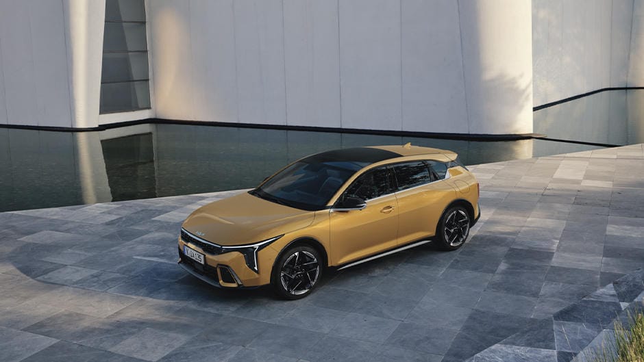 The Kia K4 parked by a building