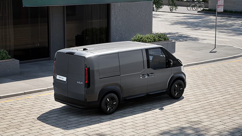 Gray Kia PV5 Cargo van parked on a city street