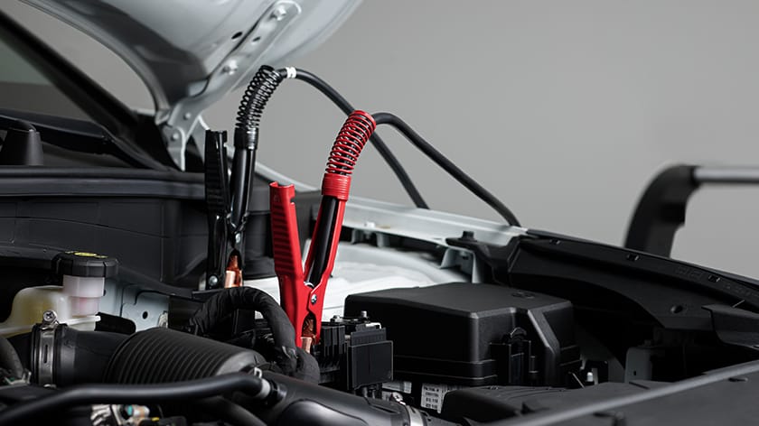Jumper cables attached to car battery