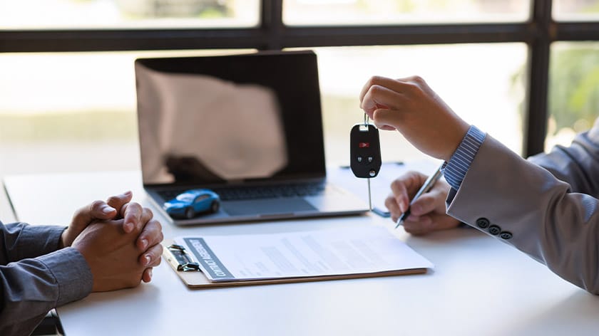 Hand of businessman car saleman handing over your new car keys