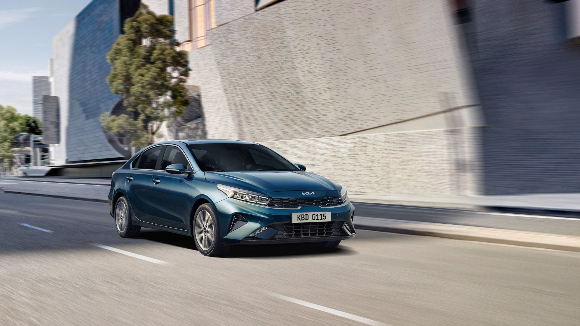 A blue K3 is driving down a city street