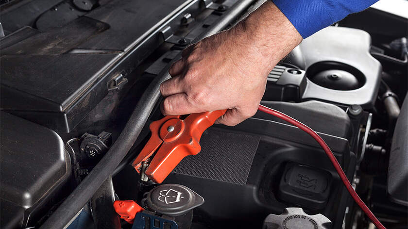 Close-up of a hand making car battery to jump start