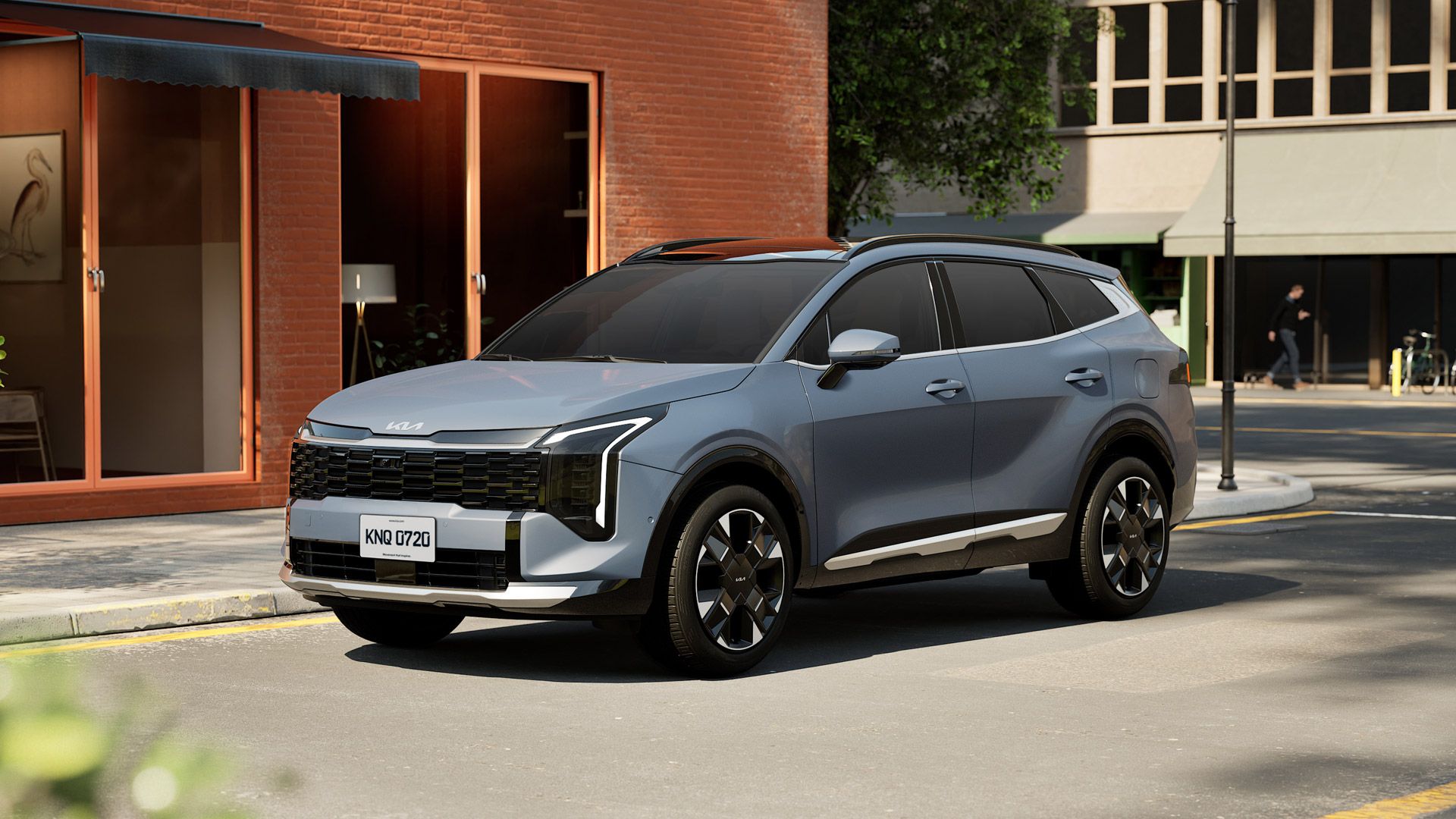 Front view of EV9 parked next to a high wall