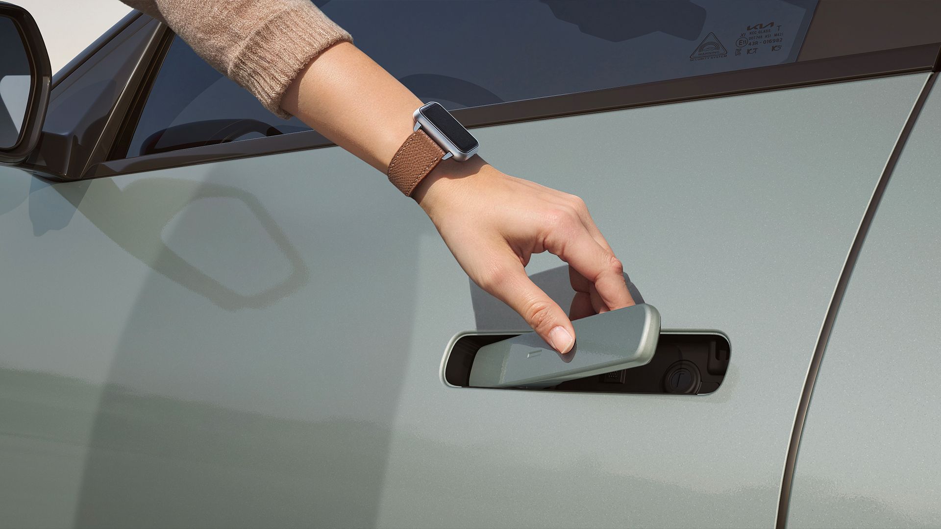Hand wearing a smartwatch unlocking the vehicle door using a digital key