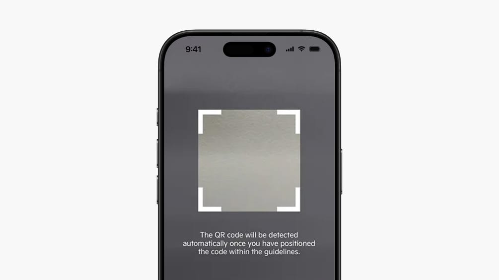 Smartphone scanning a QR code to register the vehicle