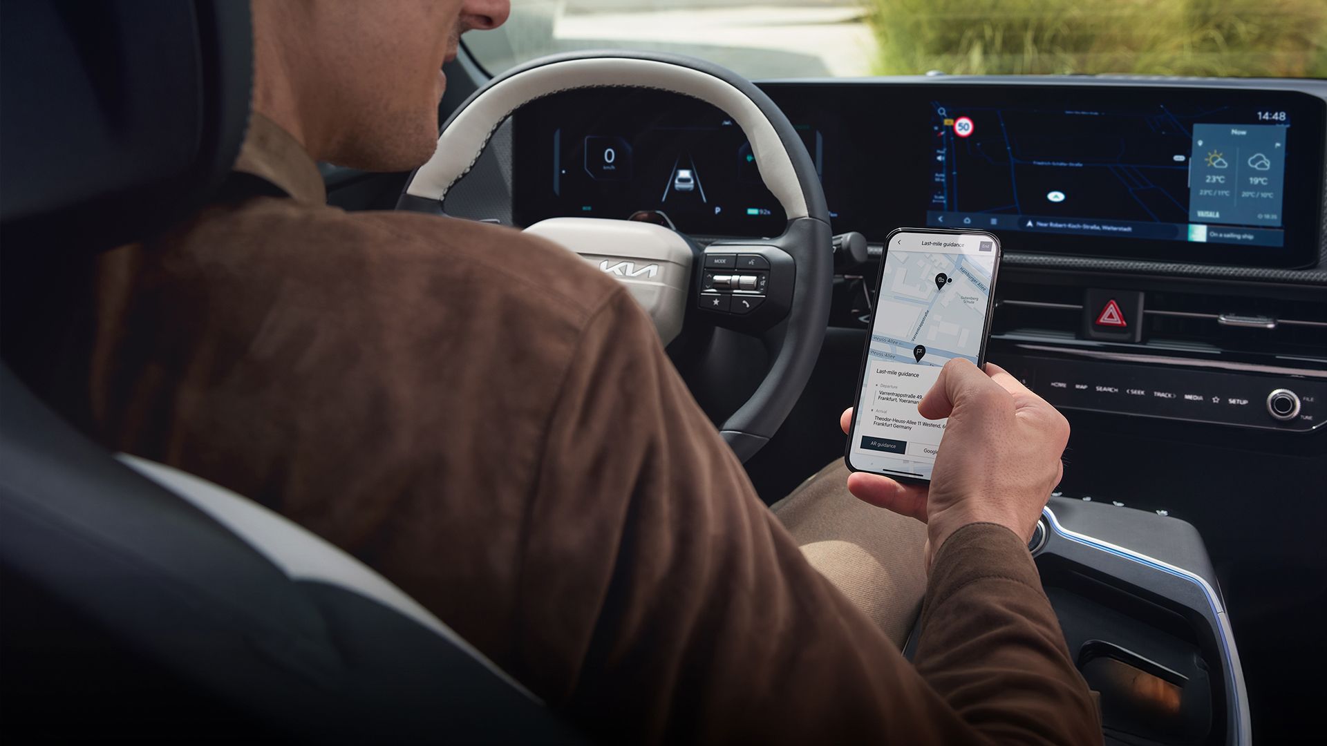 Driver inside a Kia vehicle using the Kia Connect app