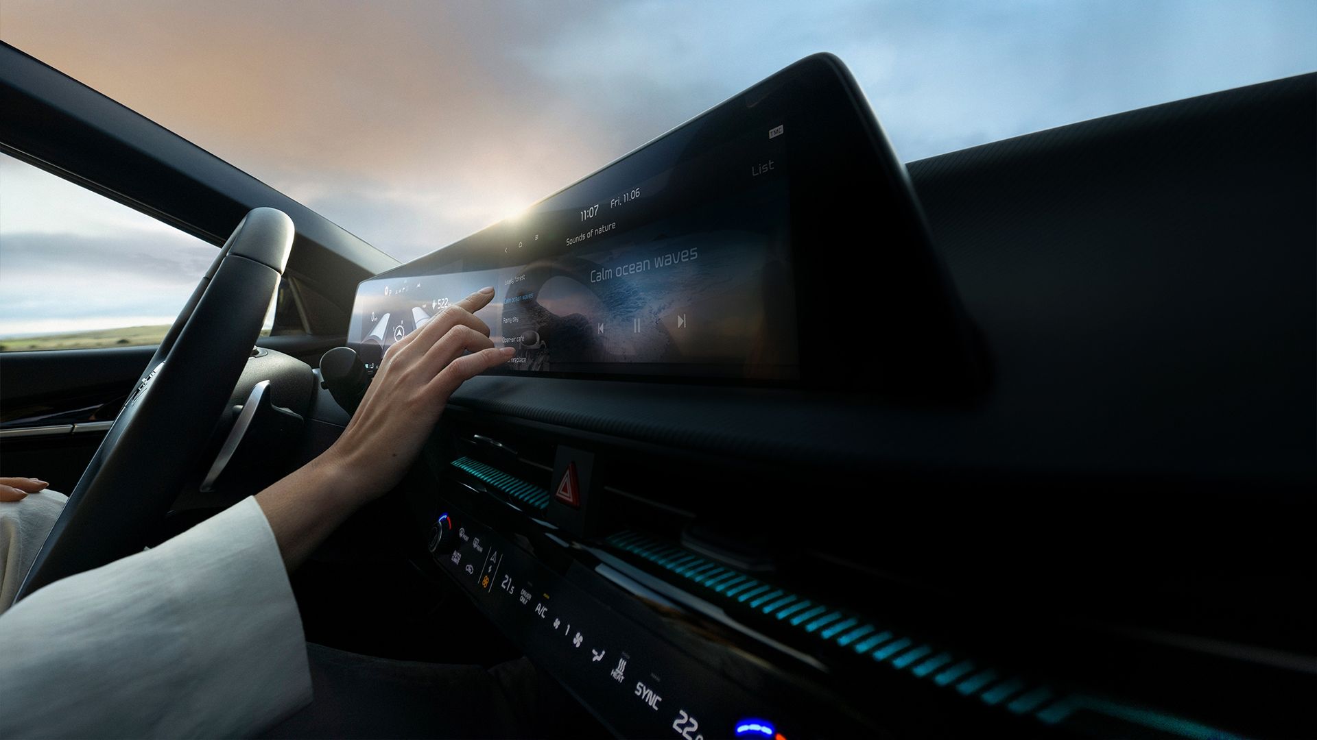 Person interacting with the Kia infotainment display using touch controls