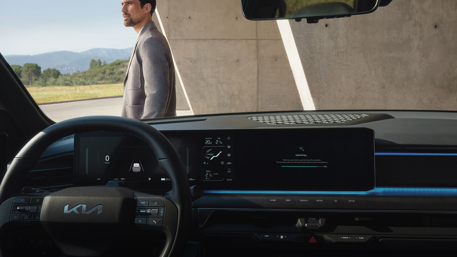 Cockpit view with infotainment screen showing a software update in progress