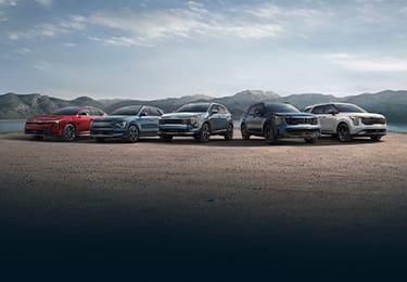 2026 K4 GT-Line Turbo, 2026 Niro Hybrid SX, 2026 Sportage Hybrid SX Prestige AWD, 2026 Sorento Hybrid SX Prestige AWD, and 2026 Carnival MPV Hybrid SX Prestige shown with optional features.