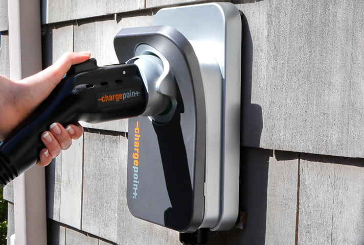 ChargePoint Home Charger being mounted back on the wall after being utilized to charge an electric vehicle, close-up