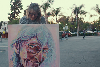 A Homeless Woman Poses With Her Portrait Painted By Brian Peterson