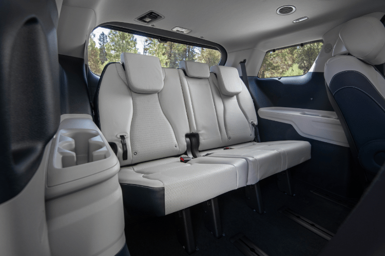 2025 Kia Carnival MPV Hybrid interior view, three-quarter view of the third row seats, featuring three spacious seats