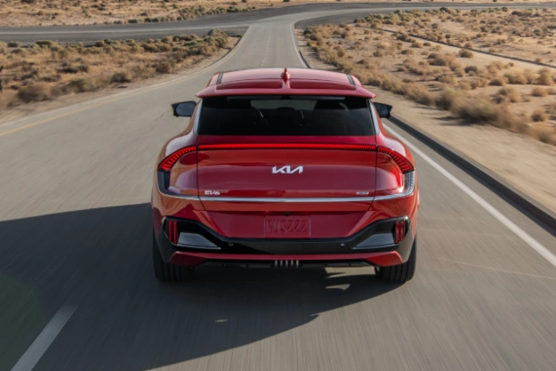 2023 Kia EV6 In Red, Driving Down A Desert Road Side-View