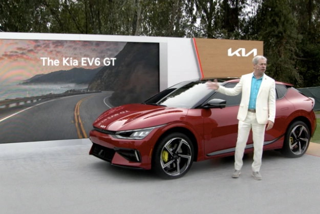 Kia EV6 GT Parked At Its Unveiling Event As The Speaker Showcases The Vehicle 