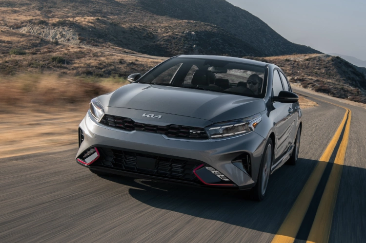 2022 Kia Forte in gray, three-quarter view action shot of front and driver side