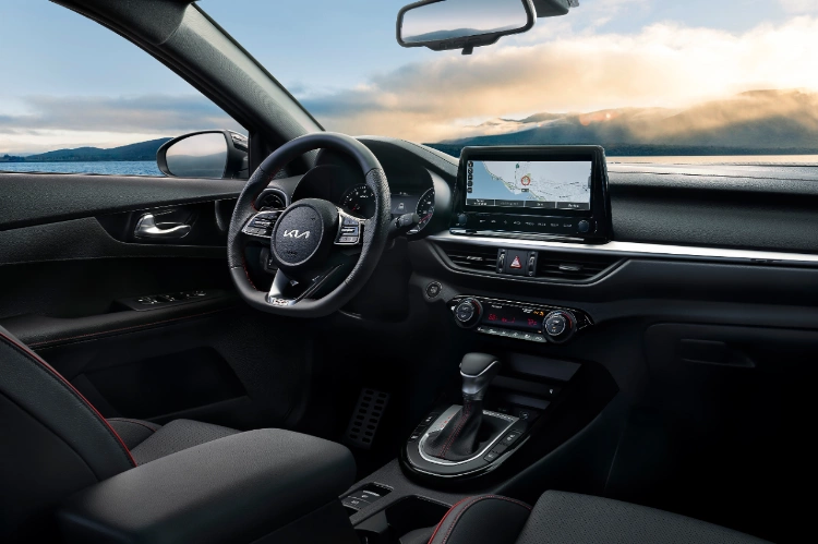 2022 Kia Forte driver side cockpit and center console technology with large infotainment screen among stylish black interior 