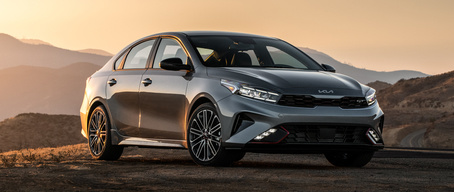 2022 Kia Forte Parked In Front Of Mountains At Sunset Three-Quarter View