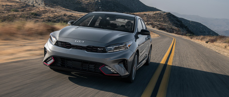 2022 Kia Forte With A Turbocharged Engine Driving Fast In The Mountains Three-Quarter View