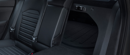 2022 Kia Forte with black interior, close-up of rear bench seats with left side folded to show trunk access