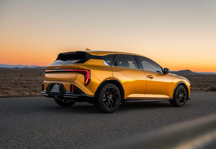 An Exterior Shot of the Golden Yellow 2026 K4 Hatchback GT-Line Turbo out in the desert roads.