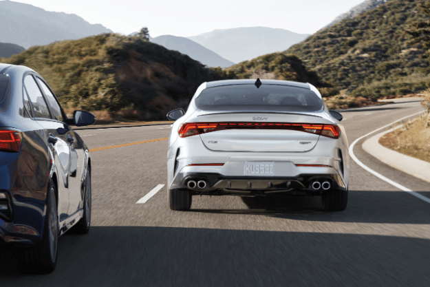 2022 Kia K5 Driving Near Mountains Rear View