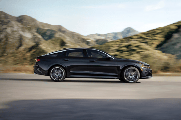 2022 Kia K5 Driving Near Mountains Side View
