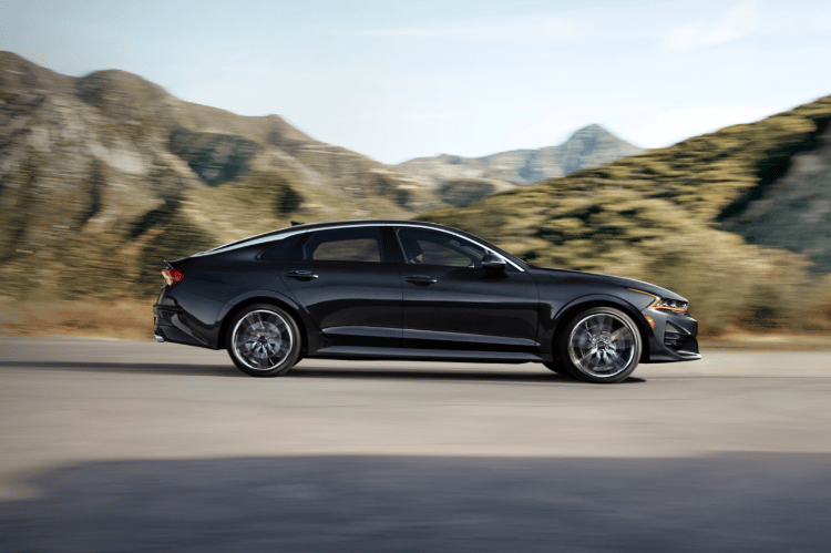 2022 Kia K5 Driving Near Mountains Side View