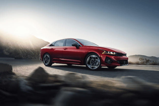 2022 Kia K5 GT-Line Driving Near Mountains Three-Quarter View