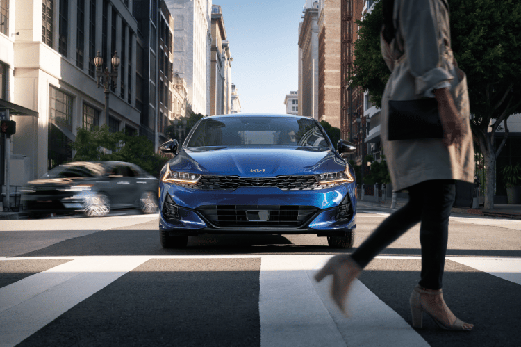 2022 Kia K5 Driving In A City Front View