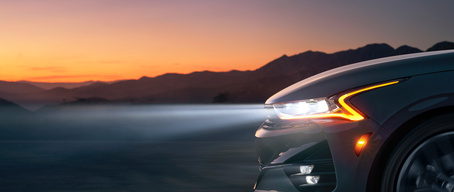 2022 Kia K5 Driving At Sunset Headlight Close-Up
