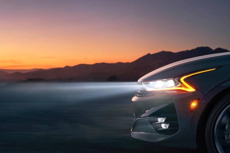 2023 Kia K5 Driving At Sunset With LED Headlights Close-Up