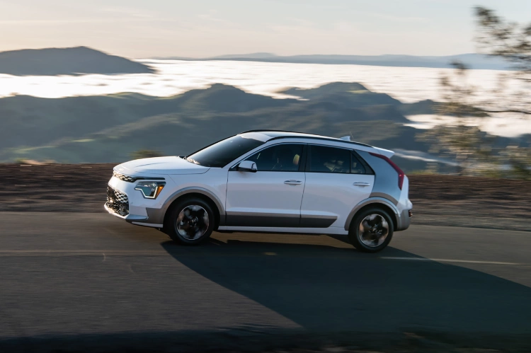 2023 Kia Niro EV Driving Up A Steep Incline In The Mountains Side View