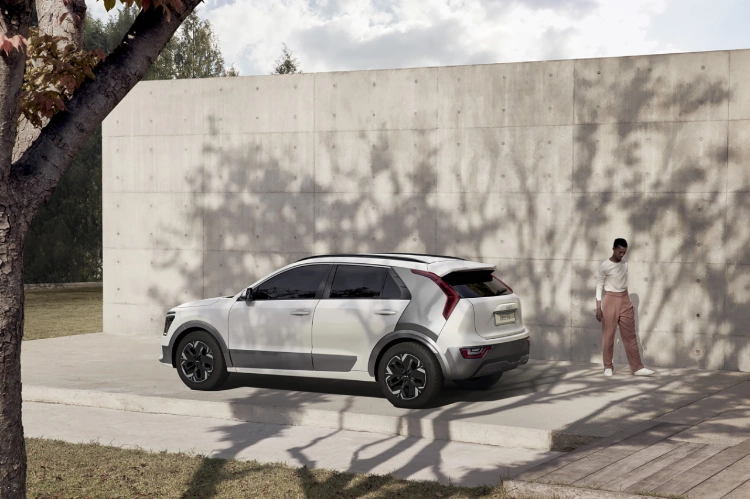 2023 Kia Niro EV Parked In Front Of A Stone Wall Rear Three-Quarter View