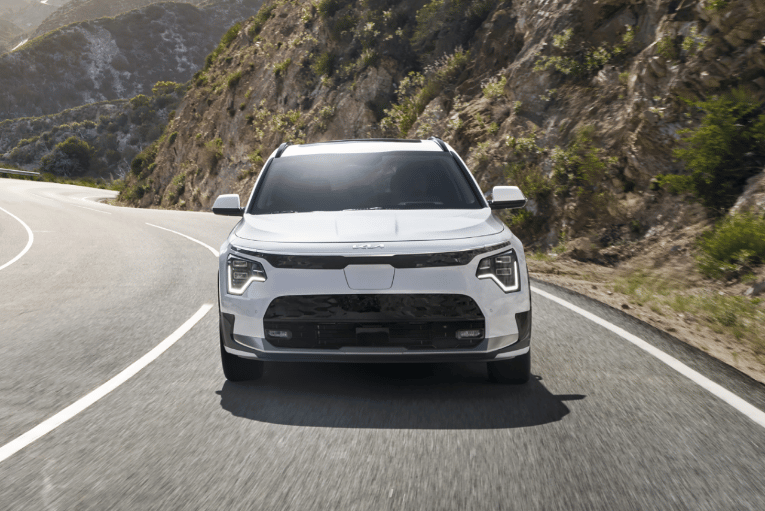 Front view of 2024 Kia Niro EV driving on highway. 