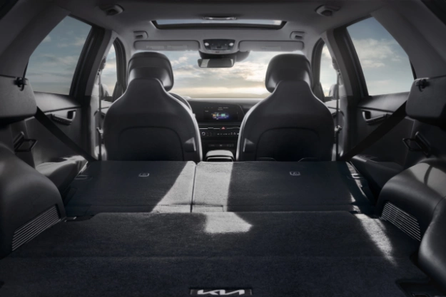 2023 Niro PHEV with gray interior, view of extensive cargo space with rear seats lowered.