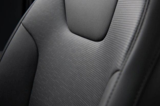 2023 Niro PHEV with gray interior, close-up of front seat leatherette pattern.