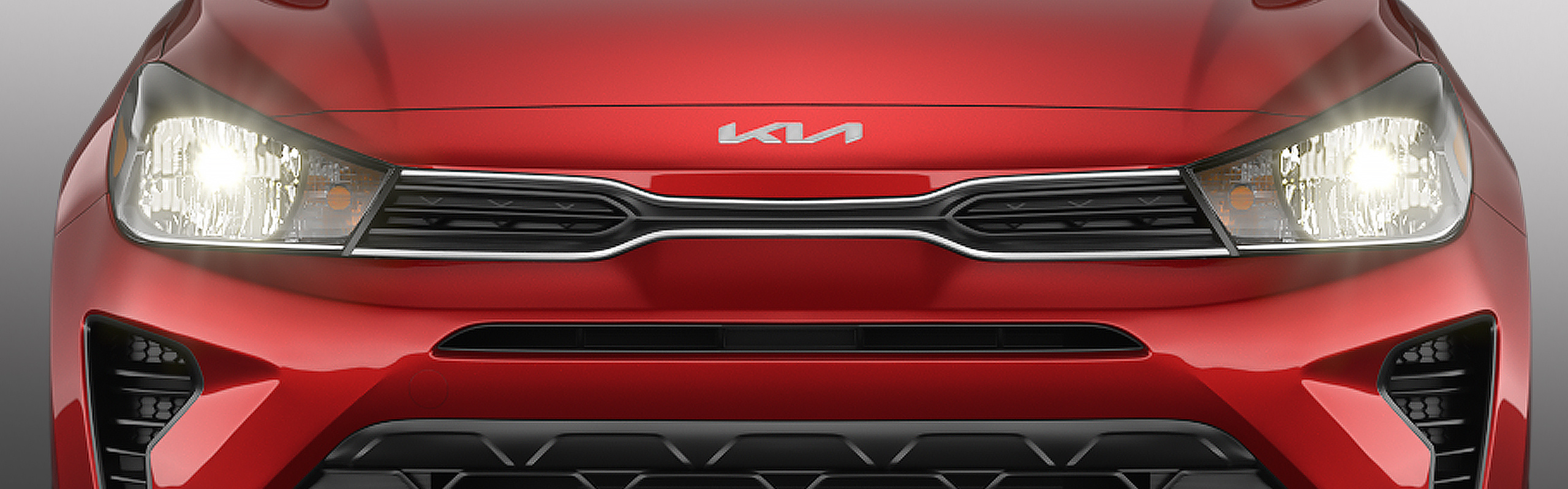 Vista frontal del diseño de los faros delanteros de led del Kia Rio 2023 de 5 puertas en rojo