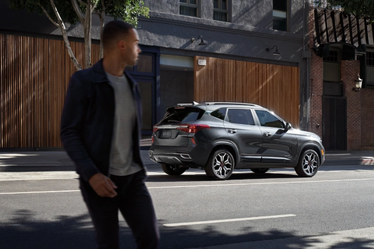 2022 Kia Seltos With A Man In The Foreground Rear Three-Quarter View