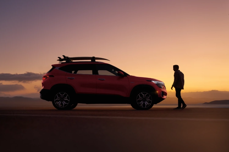 2022 Kia Seltos Parked At Sunset Next To A Man Side View