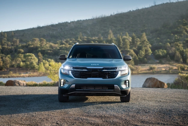 2024 Kia Seltos Parked in Front of a Hill-Side Lake Landscape Front-View